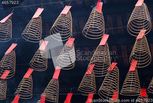 Image of Spiral incense burning hanging in Vietnamese temple
