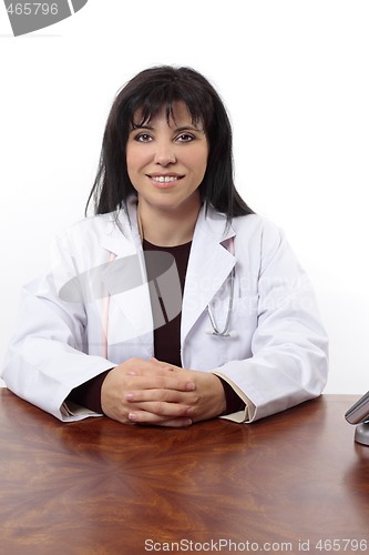 Image of Smiling doctor sitting at desk