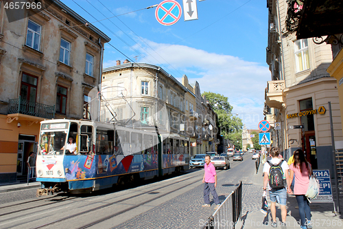 Image of busy street in Lviv with people and tram