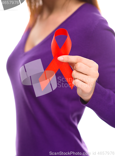 Image of Woman is holding the red awareness ribbon