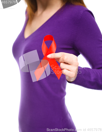 Image of Woman is holding the red awareness ribbon