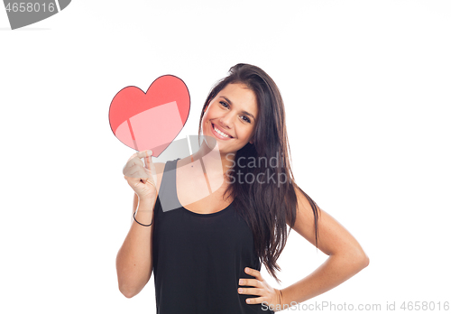 Image of beautiful happy young woman who is holding a big red heart for v