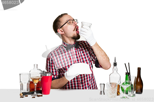 Image of Expert barman is making cocktail at studio