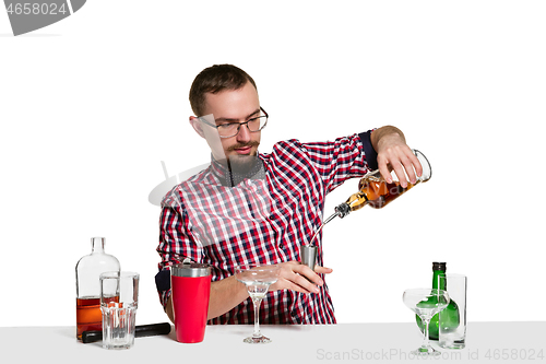 Image of Expert barman is making cocktail at studio