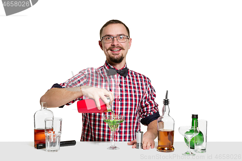 Image of Expert barman is making cocktail at studio