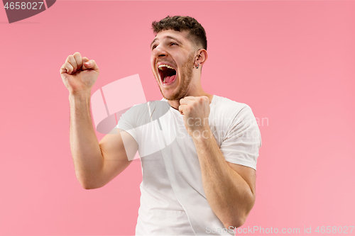 Image of Winning success man happy ecstatic celebrating being a winner. Dynamic energetic image of male model