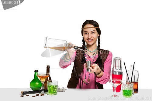 Image of Expert female barman is making cocktail at studio