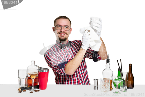 Image of Expert barman is making cocktail at studio