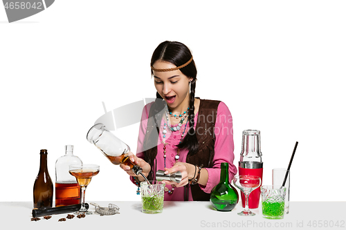 Image of Expert female barman is making cocktail at studio