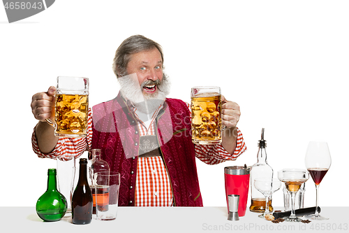 Image of Expert barman with beer at studio