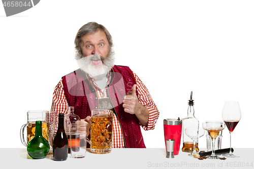 Image of Expert barman with beer at studio