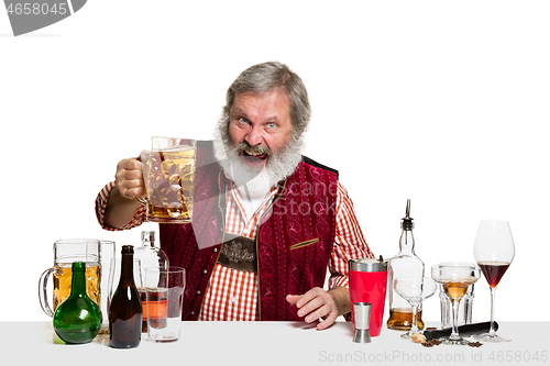 Image of Expert barman with beer at studio