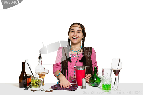 Image of Expert female barman is making cocktail at studio