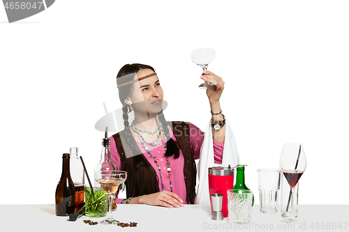 Image of Expert female barman is making cocktail at studio