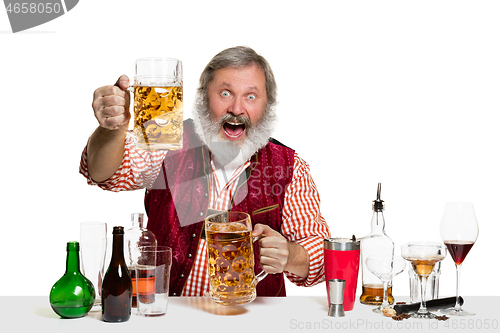 Image of Expert barman with beer at studio