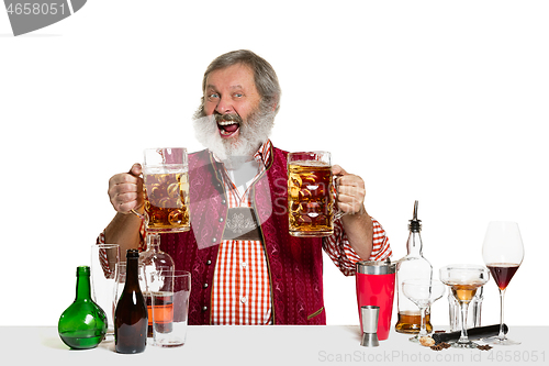 Image of Expert barman with beer at studio