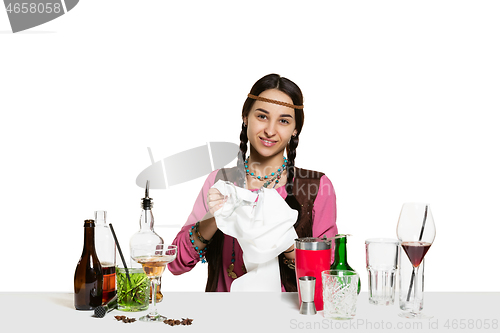 Image of Expert female barman is making cocktail at studio