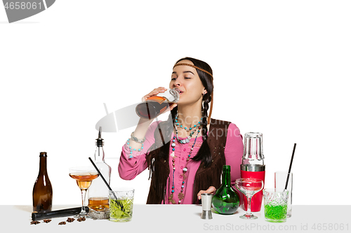 Image of Expert female barman is making cocktail at studio