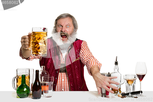 Image of Expert barman with beer at studio