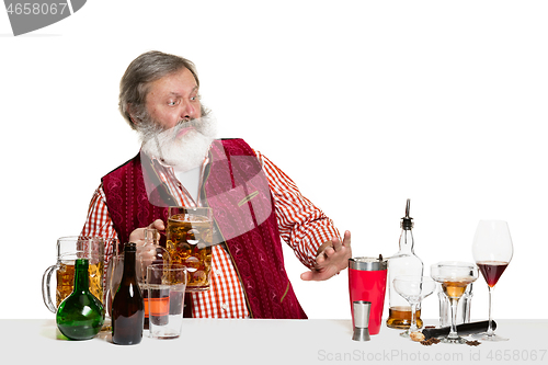 Image of Expert barman with beer at studio