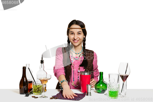 Image of Expert female barman is making cocktail at studio