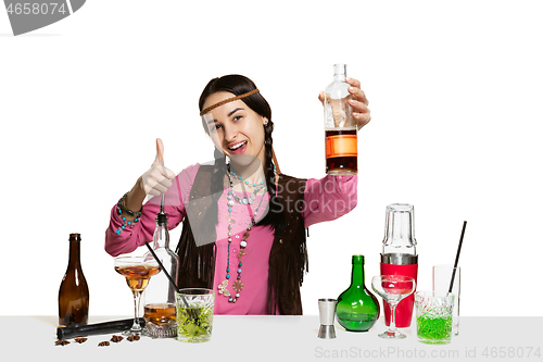 Image of Expert female barman is making cocktail at studio