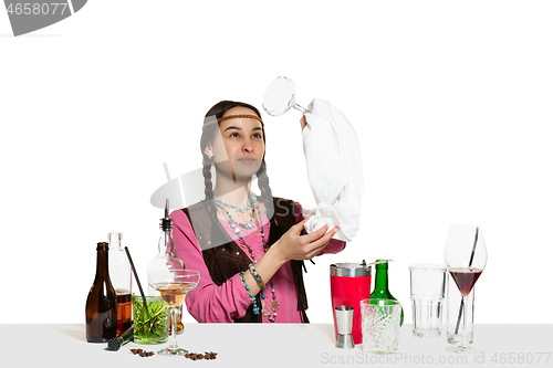 Image of Expert female barman is making cocktail at studio