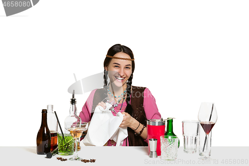 Image of Expert female barman is making cocktail at studio