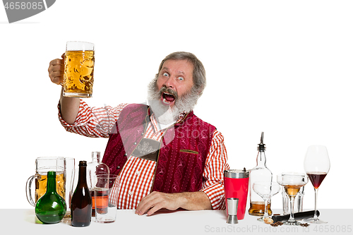 Image of Expert barman with beer at studio