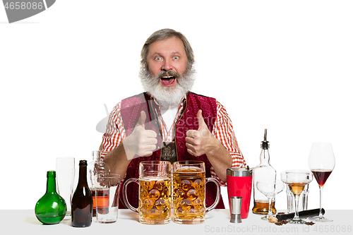 Image of Expert barman with beer at studio