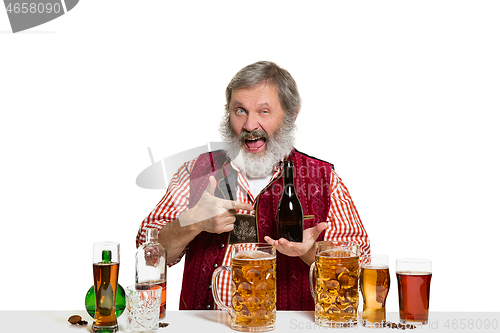 Image of Expert barman with beer at studio