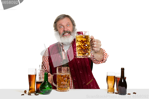 Image of Expert barman with beer at studio