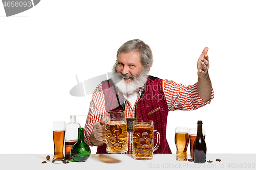 Image of Expert barman with beer at studio