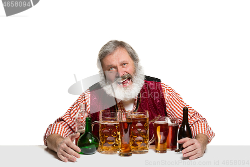 Image of Expert barman with beer at studio