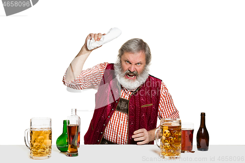 Image of Expert barman with beer at studio