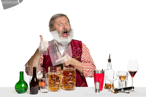 Image of Expert barman with beer at studio