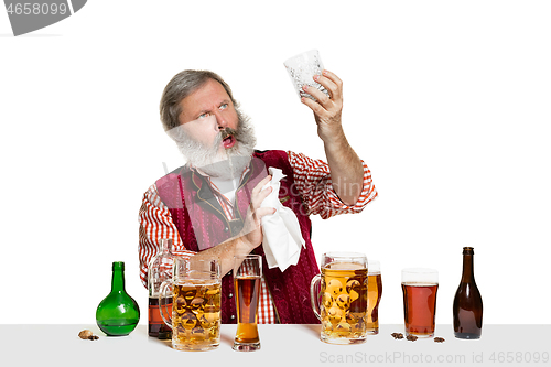 Image of Expert barman with beer at studio