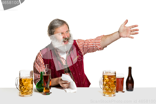 Image of Expert barman with beer at studio