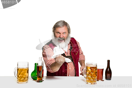 Image of Expert barman with beer at studio