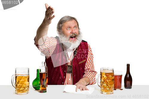 Image of Expert barman with beer at studio