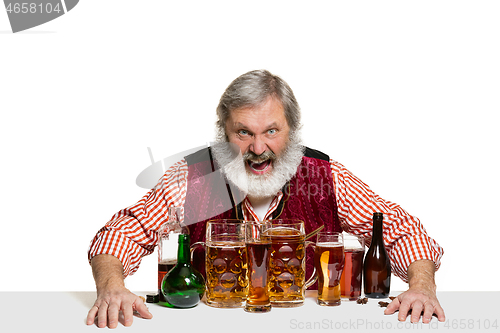 Image of Expert barman with beer at studio