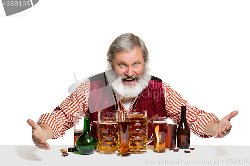 Image of Expert barman with beer at studio