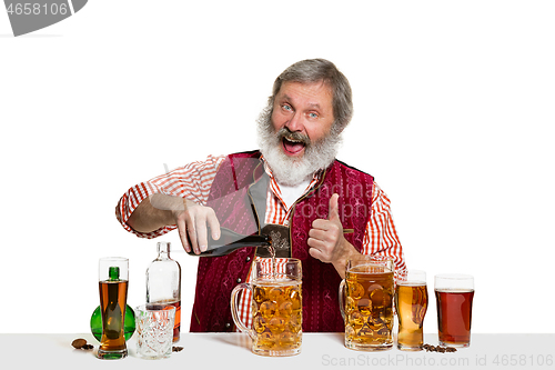 Image of Expert barman with beer at studio