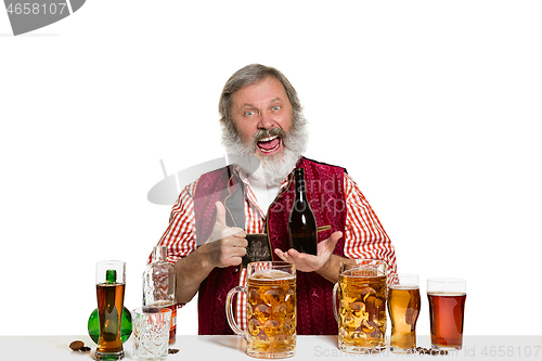 Image of Expert barman with beer at studio