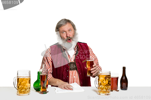 Image of Expert barman with beer at studio