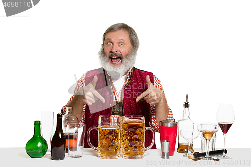 Image of Expert barman with beer at studio