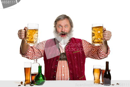 Image of Expert barman with beer at studio