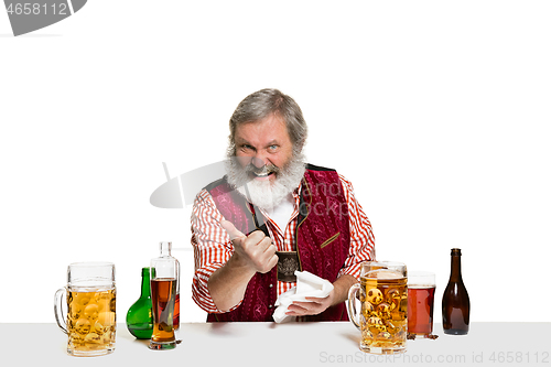 Image of Expert barman with beer at studio
