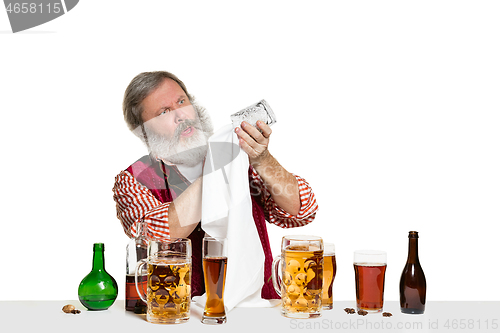 Image of Expert barman with beer at studio