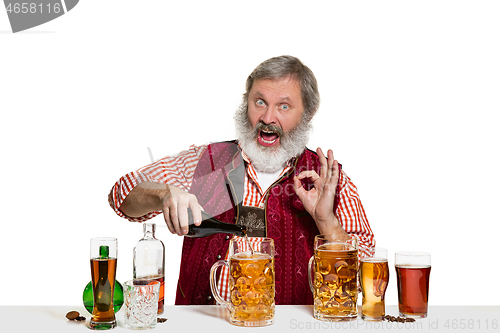 Image of Expert barman with beer at studio